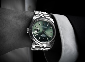Man wearing a luxury wristwatch on his arm.