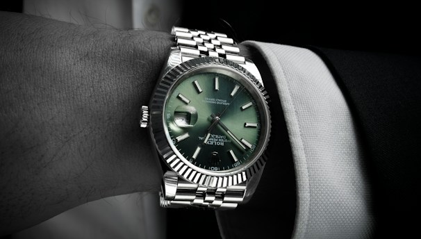 Man wearing a luxury wristwatch on his arm.